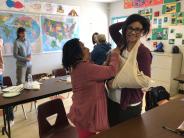 Two women practicing bandaging and splinting in First Aid class
